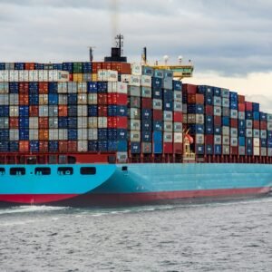 blue and red cargo ship on sea during daytime